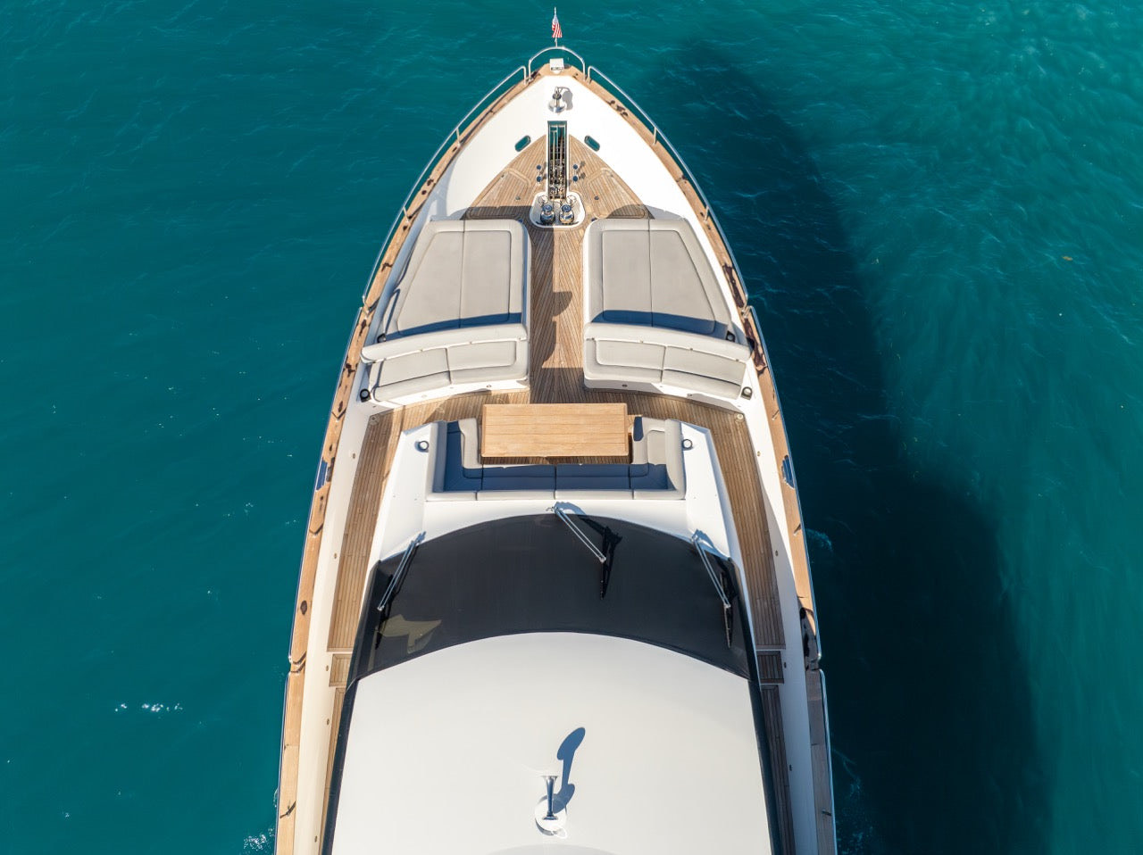 Aerial view of a yacht on turquoise water