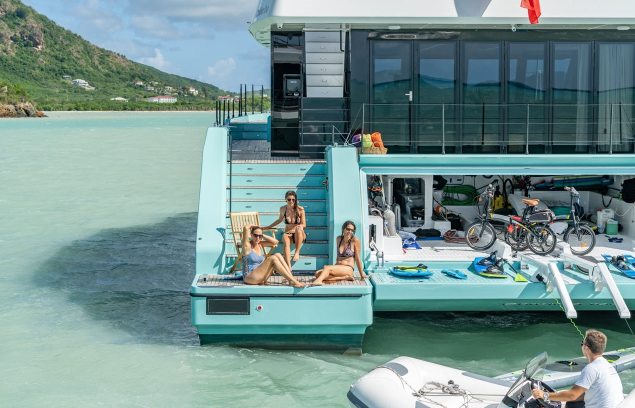 Guests on the swim platform of a catamaran